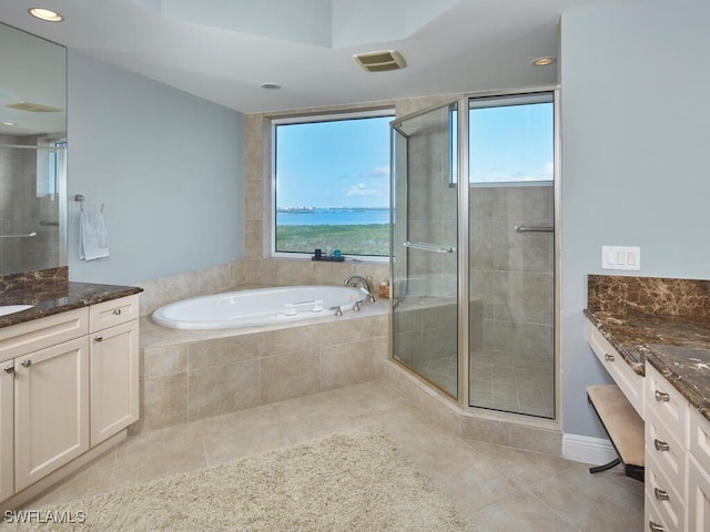 bathroom with vanity, plenty of natural light, and separate shower and tub