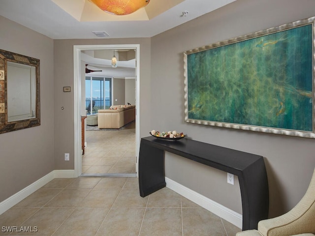 hall featuring light tile patterned flooring