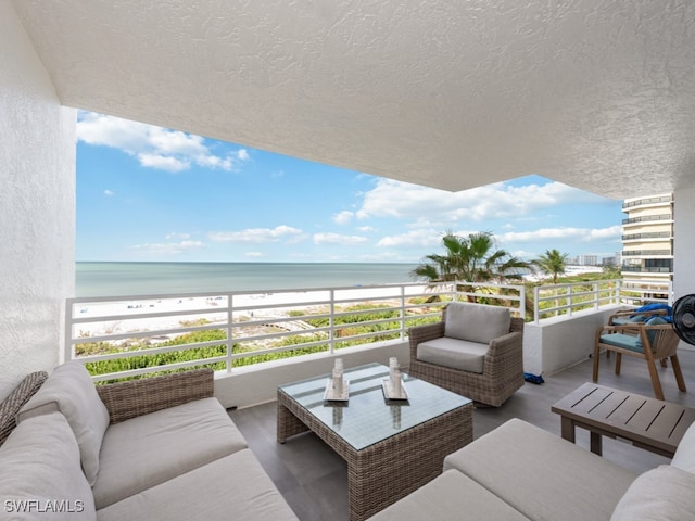 balcony with a beach view, outdoor lounge area, and a water view