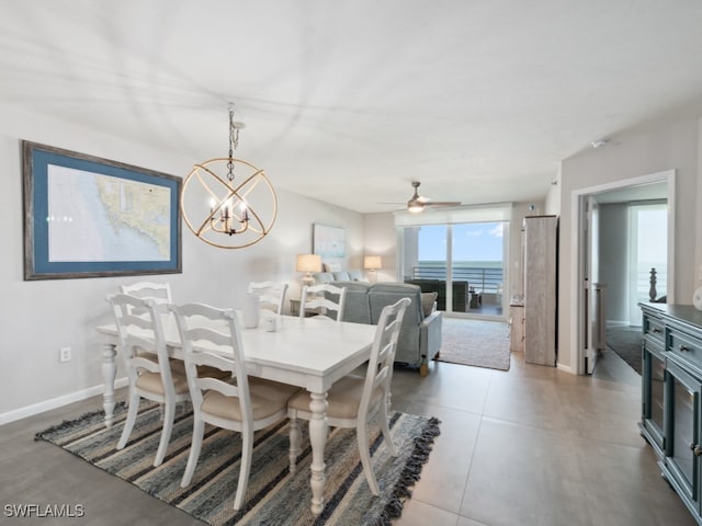 dining room featuring ceiling fan with notable chandelier