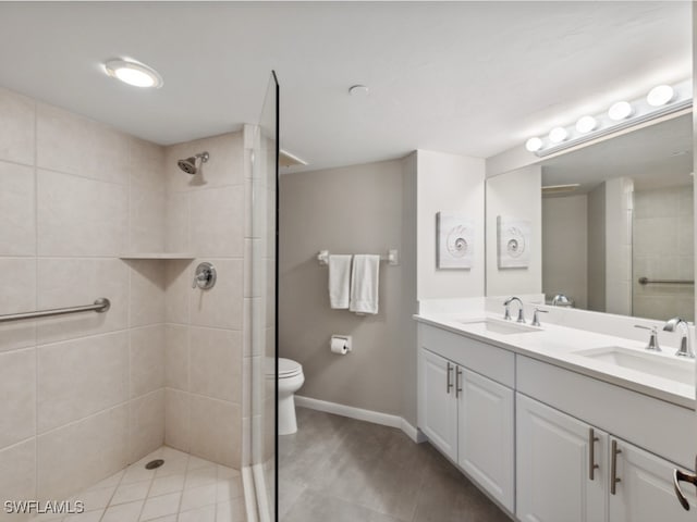 bathroom featuring tiled shower, vanity, and toilet