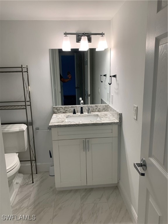 bathroom with vanity and toilet