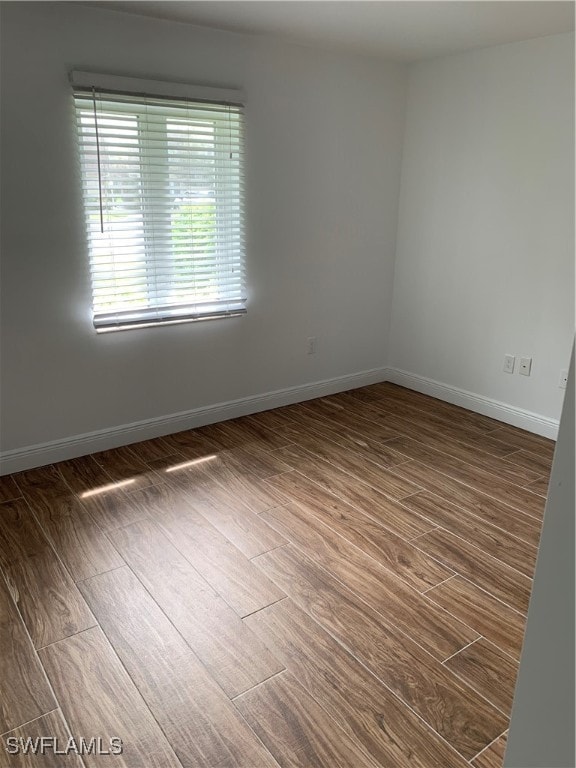 spare room with dark wood-type flooring