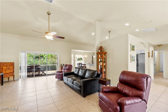 tiled living room featuring ceiling fan and high vaulted ceiling