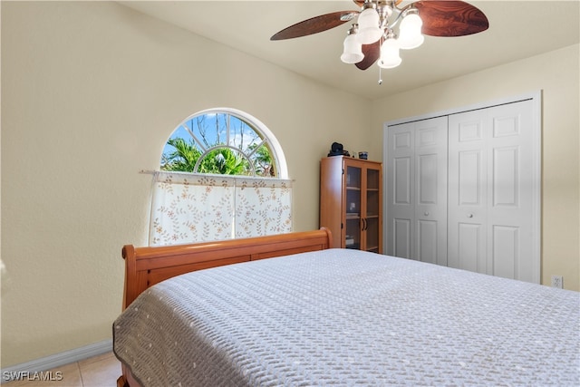 tiled bedroom featuring a closet and ceiling fan