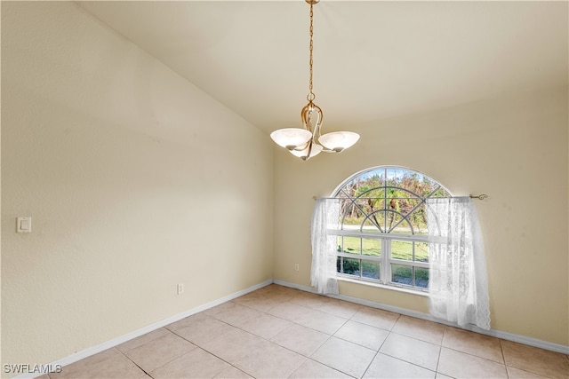 tiled spare room with a notable chandelier and lofted ceiling