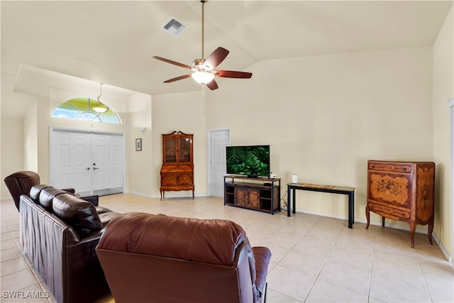 tiled living room with high vaulted ceiling and ceiling fan