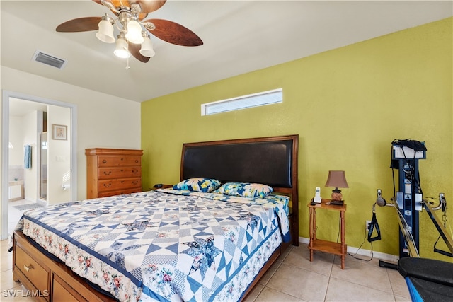 bedroom with ceiling fan, light tile patterned flooring, and ensuite bathroom