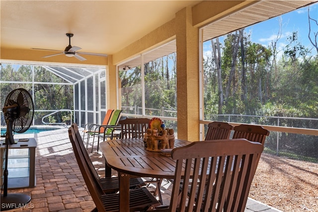 sunroom / solarium featuring plenty of natural light and ceiling fan