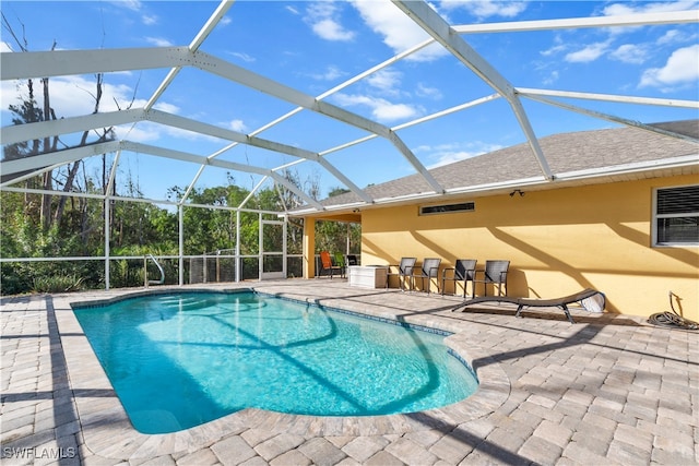 view of pool with a patio and a lanai