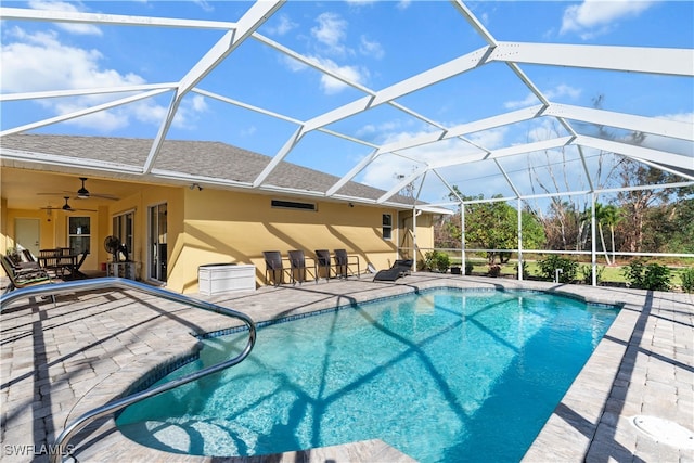 view of swimming pool featuring a patio, a lanai, and ceiling fan