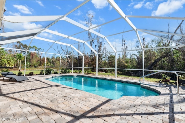 view of swimming pool featuring a patio area and a lanai