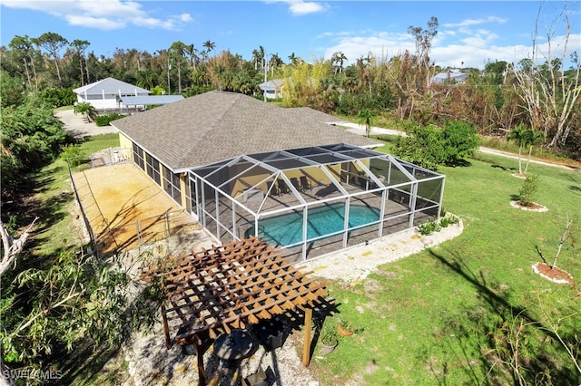 view of pool featuring a patio, glass enclosure, and a lawn