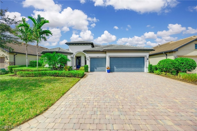 view of front of house featuring a front yard and a garage