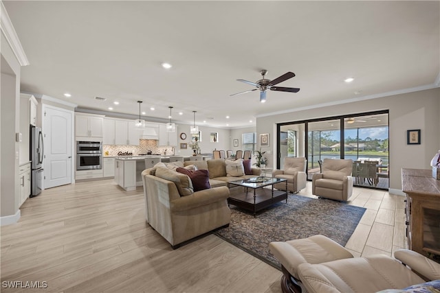 living room with ceiling fan, crown molding, and light wood-type flooring