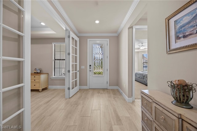 foyer featuring french doors, crown molding, light wood-type flooring, and ceiling fan