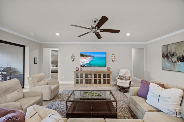 living room featuring ornamental molding, wood-type flooring, and ceiling fan