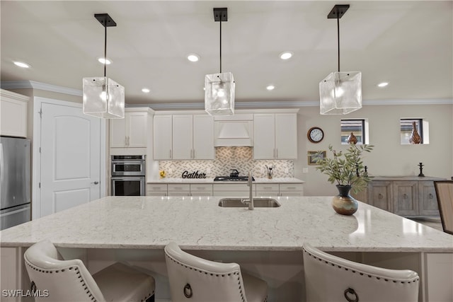 kitchen featuring sink, decorative light fixtures, and white cabinets