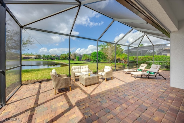 view of patio with an outdoor hangout area, a water view, and glass enclosure