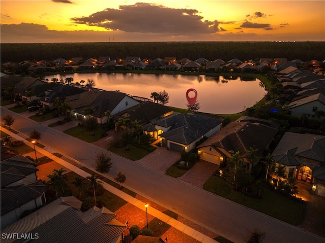 aerial view at dusk with a water view