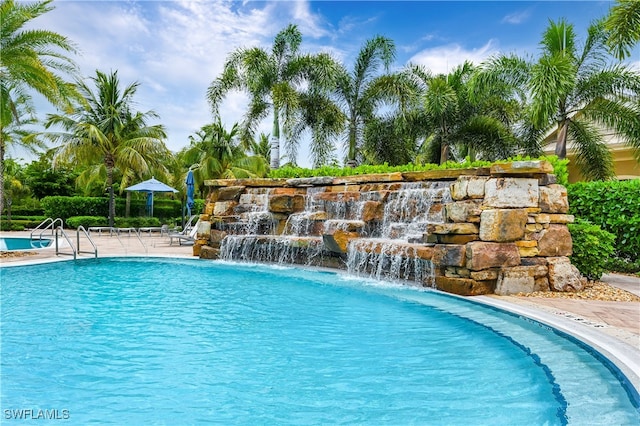 view of swimming pool featuring pool water feature