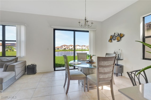 dining area with a chandelier, light tile patterned flooring, and a wealth of natural light