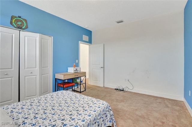 bedroom with light colored carpet and a closet