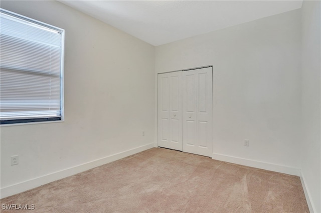 empty room featuring light colored carpet