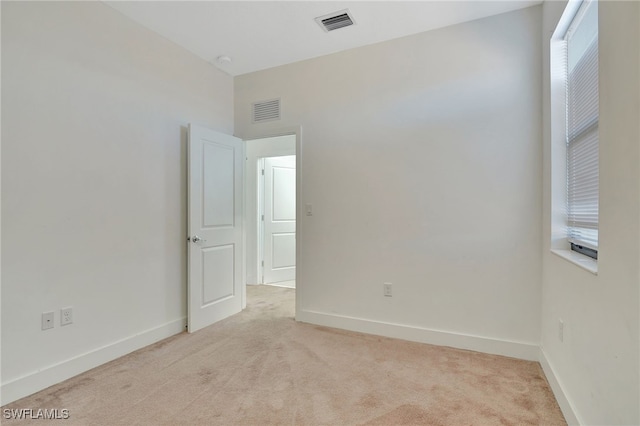 empty room featuring light carpet