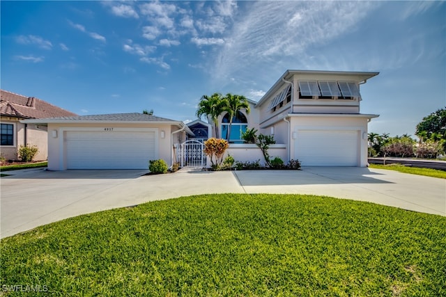 view of front of home featuring a front lawn and a garage