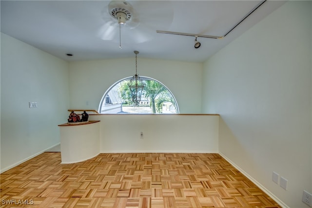 unfurnished room featuring ceiling fan, light parquet floors, and vaulted ceiling