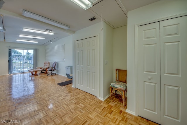 interior space with light parquet floors and vaulted ceiling