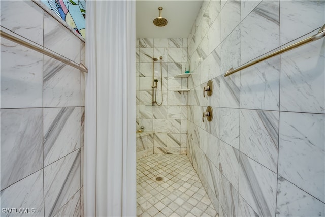 bathroom with tiled shower