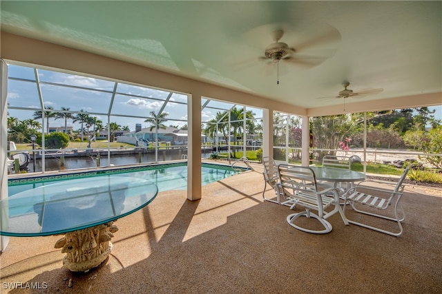 view of pool featuring a water view, ceiling fan, glass enclosure, and a patio area