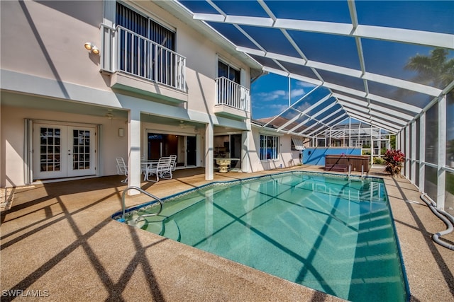 view of pool featuring a patio area, french doors, and glass enclosure