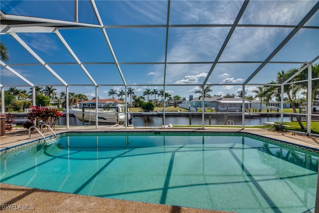 view of pool with a water view and a lanai