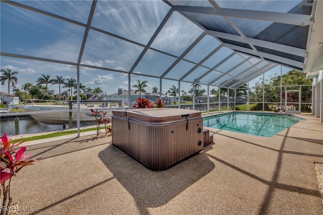 view of swimming pool featuring a water view, a patio area, a lanai, and a hot tub