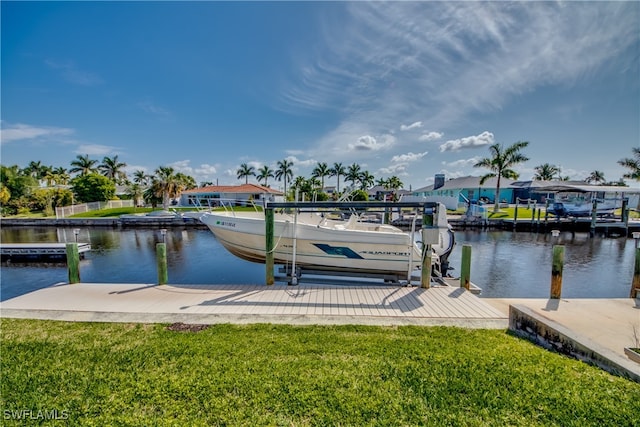 dock area with a water view and a lawn