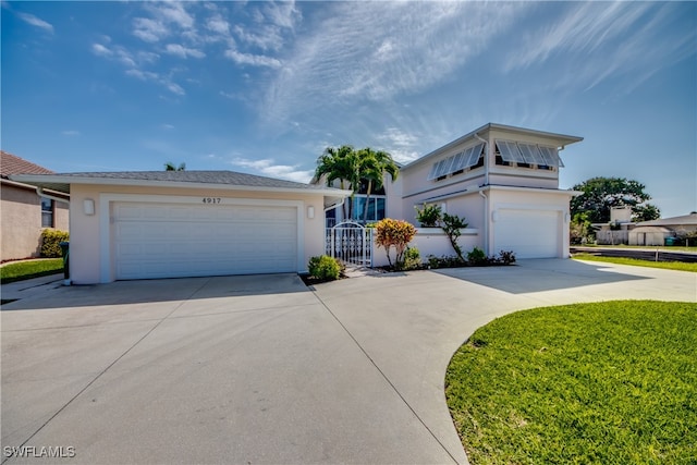 view of front of property featuring a front yard and a garage