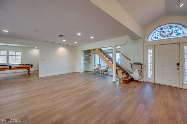 entrance foyer with light hardwood / wood-style floors, lofted ceiling, and billiards