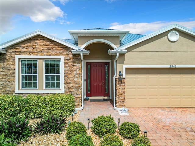 view of exterior entry featuring a garage