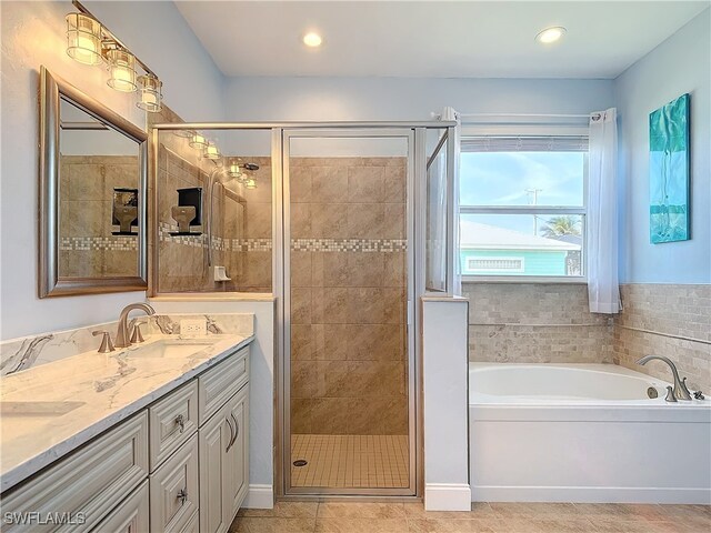 bathroom featuring vanity, tile patterned floors, and plus walk in shower