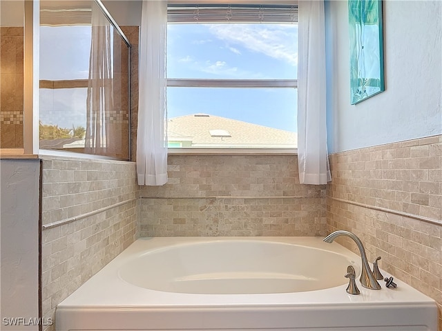 bathroom with a tub to relax in