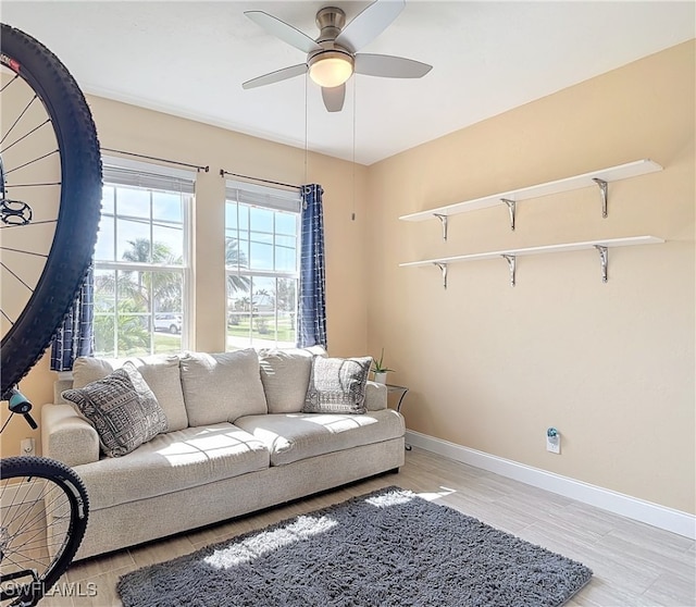 living room with light wood-type flooring and ceiling fan