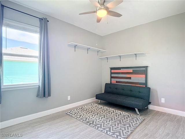 living area featuring ceiling fan and wood-type flooring