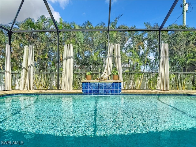 view of pool featuring pool water feature and a lanai