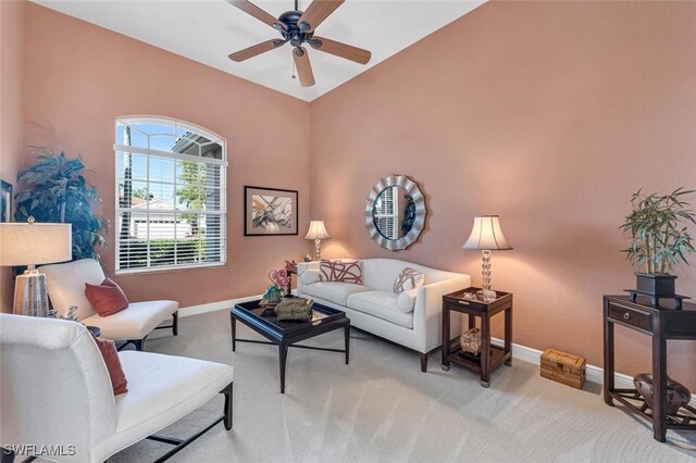 living room with ceiling fan and light colored carpet