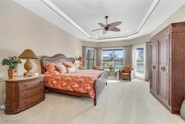 carpeted bedroom with a tray ceiling, ceiling fan, and access to outside