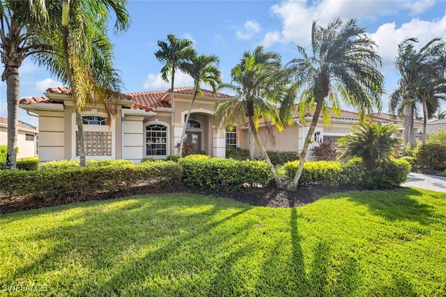 mediterranean / spanish-style house with a front yard