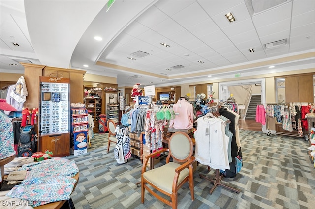 miscellaneous room with carpet floors and a tray ceiling